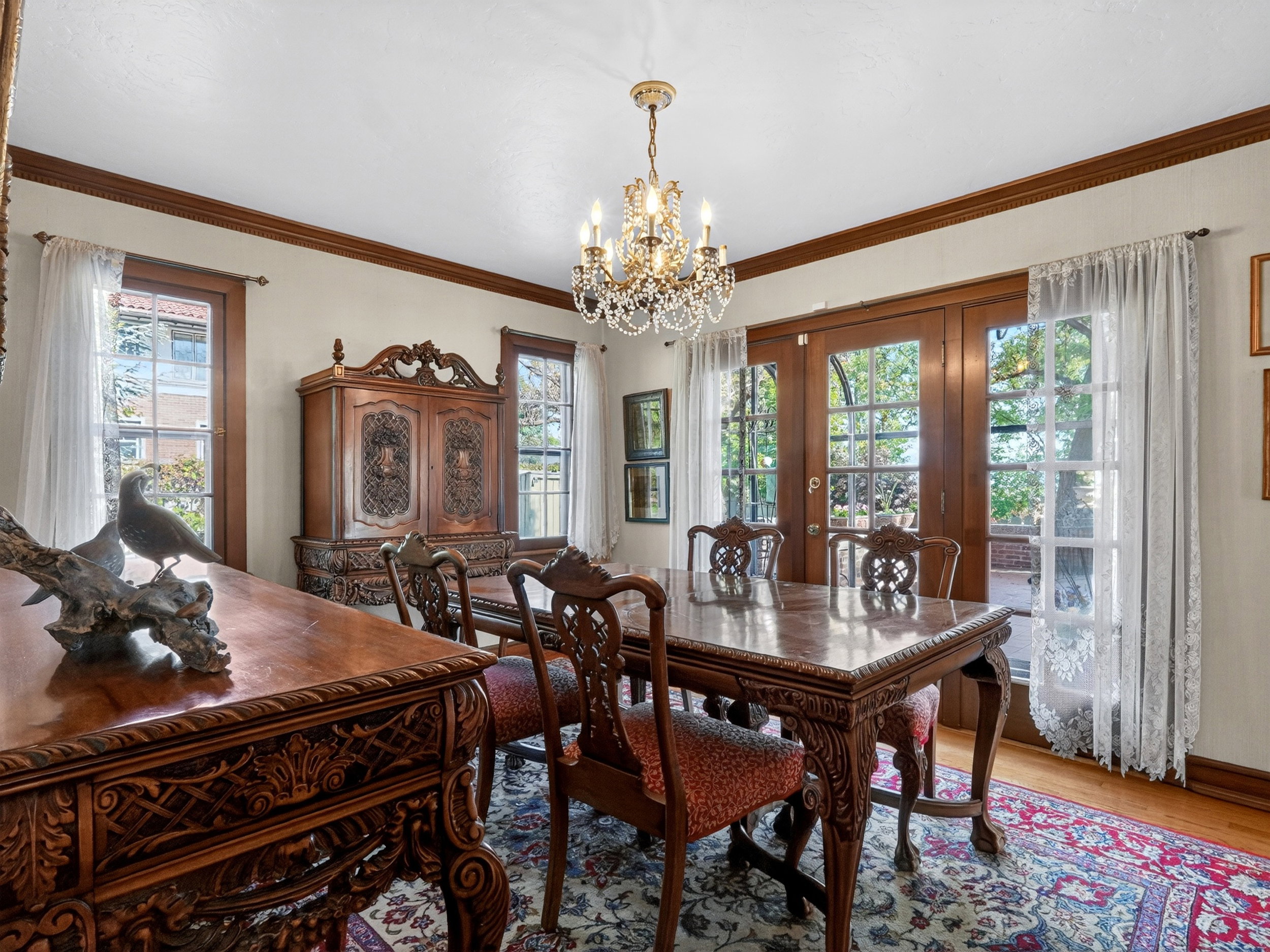 Formal dining area featuring hardwood flooring, a chandelier light fixture, and crown molding