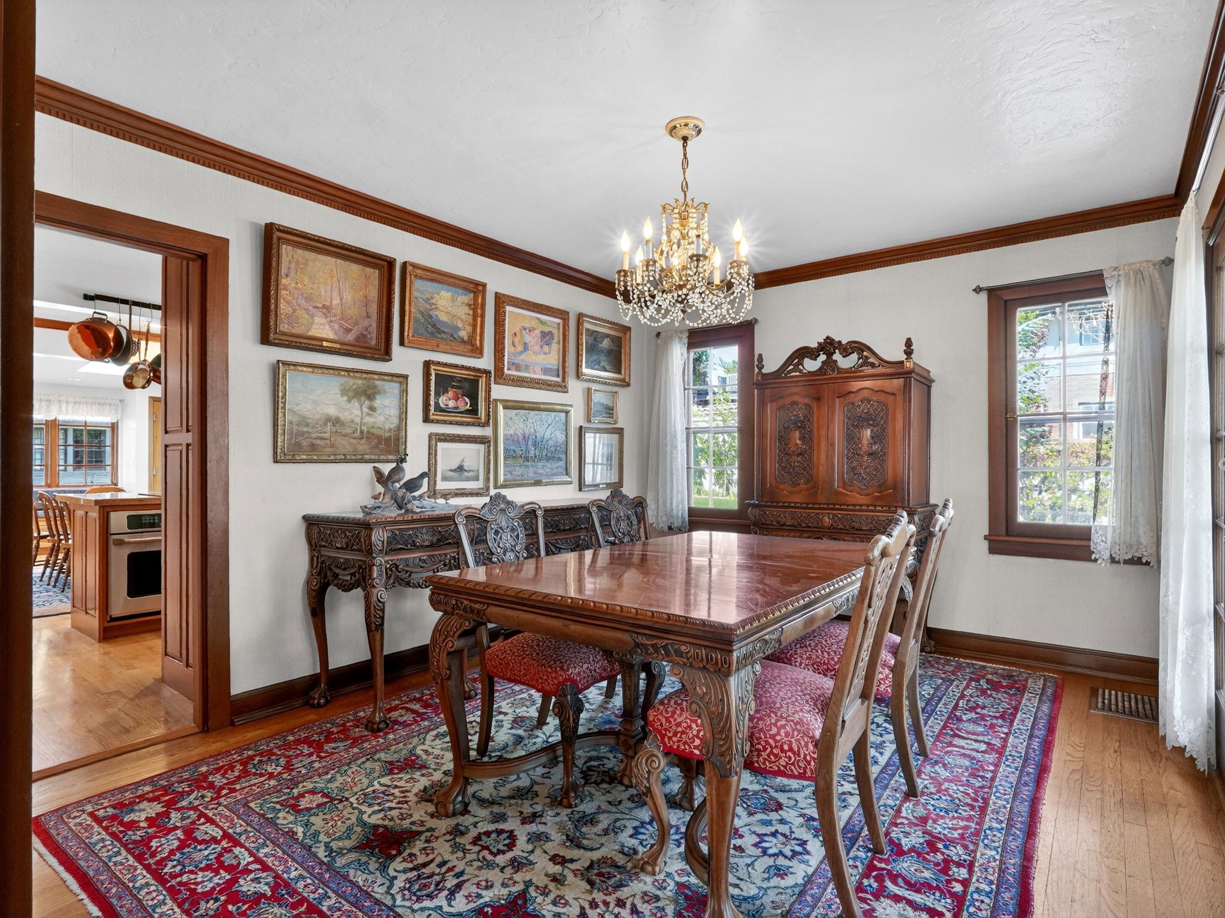 Formal dining room featuring wood-finish flooring and a central chandelier