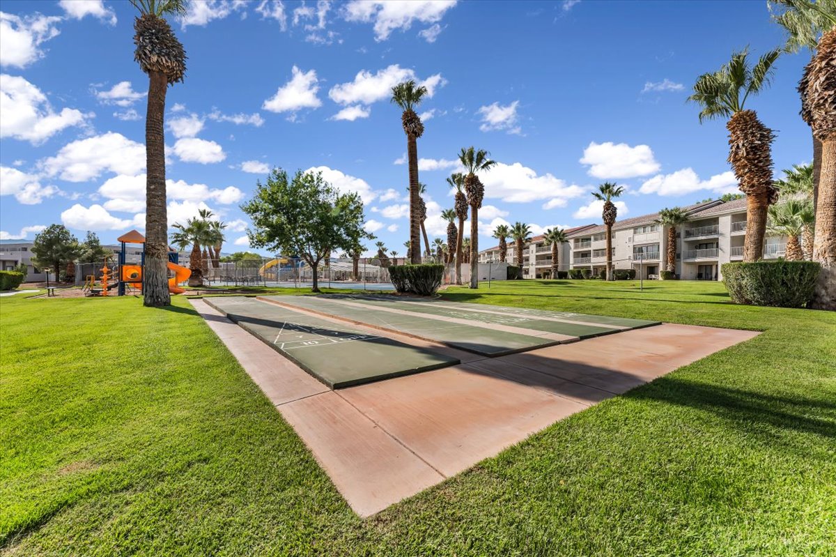 Expansive green space featuring two shuffleboard courts on a concrete base