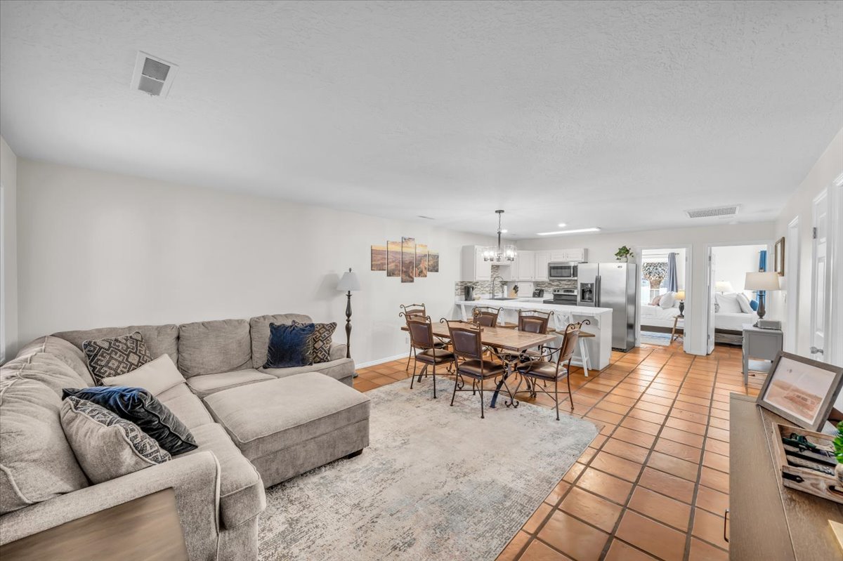 Open-concept living area with tile flooring and an integrated dining space