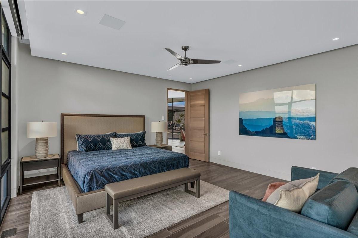 Spacious room featuring wood-finish flooring, recessed lighting, and a contemporary ceiling fan