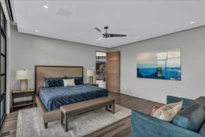 Spacious room featuring wood-finish flooring, recessed lighting, and a contemporary ceiling fan