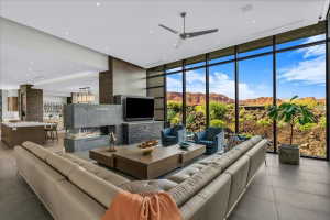 Expansive living area featuring floor-to-ceiling windows, a linear gas fireplace, and large format tile flooring