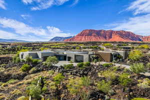 Contemporary residence featuring a flat roofline and stucco exterior