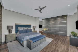 Spacious room featuring wood-finish flooring, a contemporary ceiling fan, and recessed lighting