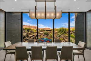 Floor-to-ceiling windows with expansive desert and mountain scenery