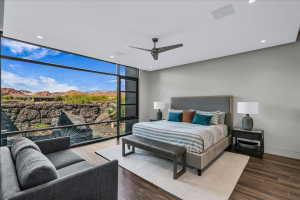 Expansive floor-to-ceiling windows with black framing showcasing desert scenery and distant mountains