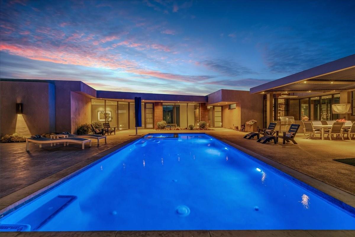 Rectangular swimming pool with integrated spa jets surrounded by concrete decking