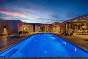 Rectangular swimming pool with integrated spa jets surrounded by concrete decking