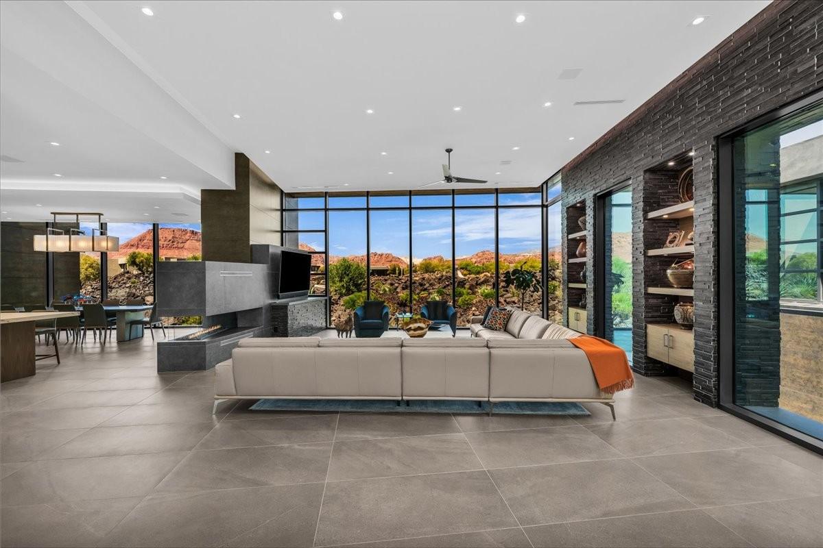 Expansive living area with large format tile flooring and a contemporary linear fireplace