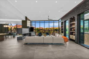 Expansive living area with large format tile flooring and a contemporary linear fireplace