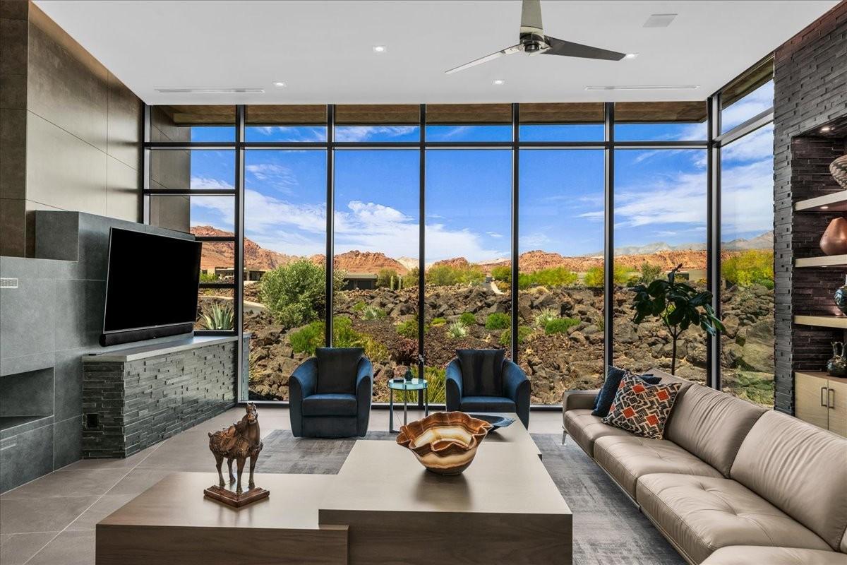 Floor-to-ceiling windows with expansive desert and mountain scenery