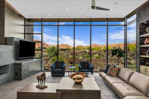 Floor-to-ceiling windows with expansive desert and mountain scenery