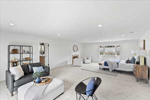 Spacious room featuring light-toned carpeting and recessed lighting