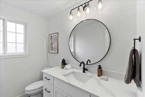 Modern bathroom vanity with a white quartz countertop and integrated rectangular sink