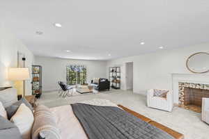 Spacious room featuring light-colored carpeting and recessed lighting