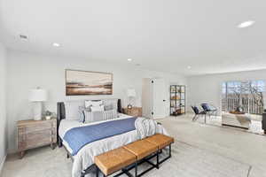 Spacious room with light-toned carpeting and recessed lighting