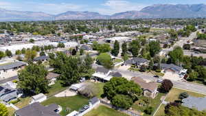 Residential neighborhood featuring mature trees and mountain backdrops