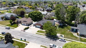 Expansive residential property featuring a large front yard, mature trees, and a concrete driveway