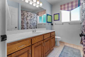 Full guest bathroom, vanity with a white countertop and a single basin sink