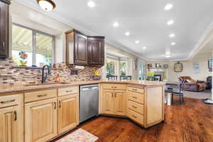 Kitchen with hardwood flooring, two-tone cabinetry, granite countertops, and a mosaic tile backsplash