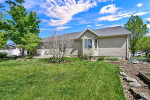 Expansive green lawn with established trees and shrubbery