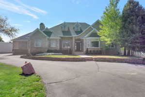 Stone and stucco exterior with a multi-gable roofline and dormer windows