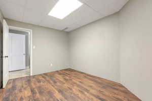 Room featuring wood-finish flooring and light gray walls