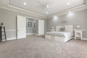 Expansive room featuring tray ceiling with recessed lighting, crown molding, chair rail, and plush carpet flooring