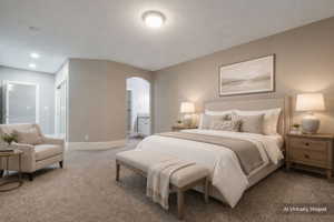 Carpeted room featuring neutral wall tones, recessed lighting, and an arched entry