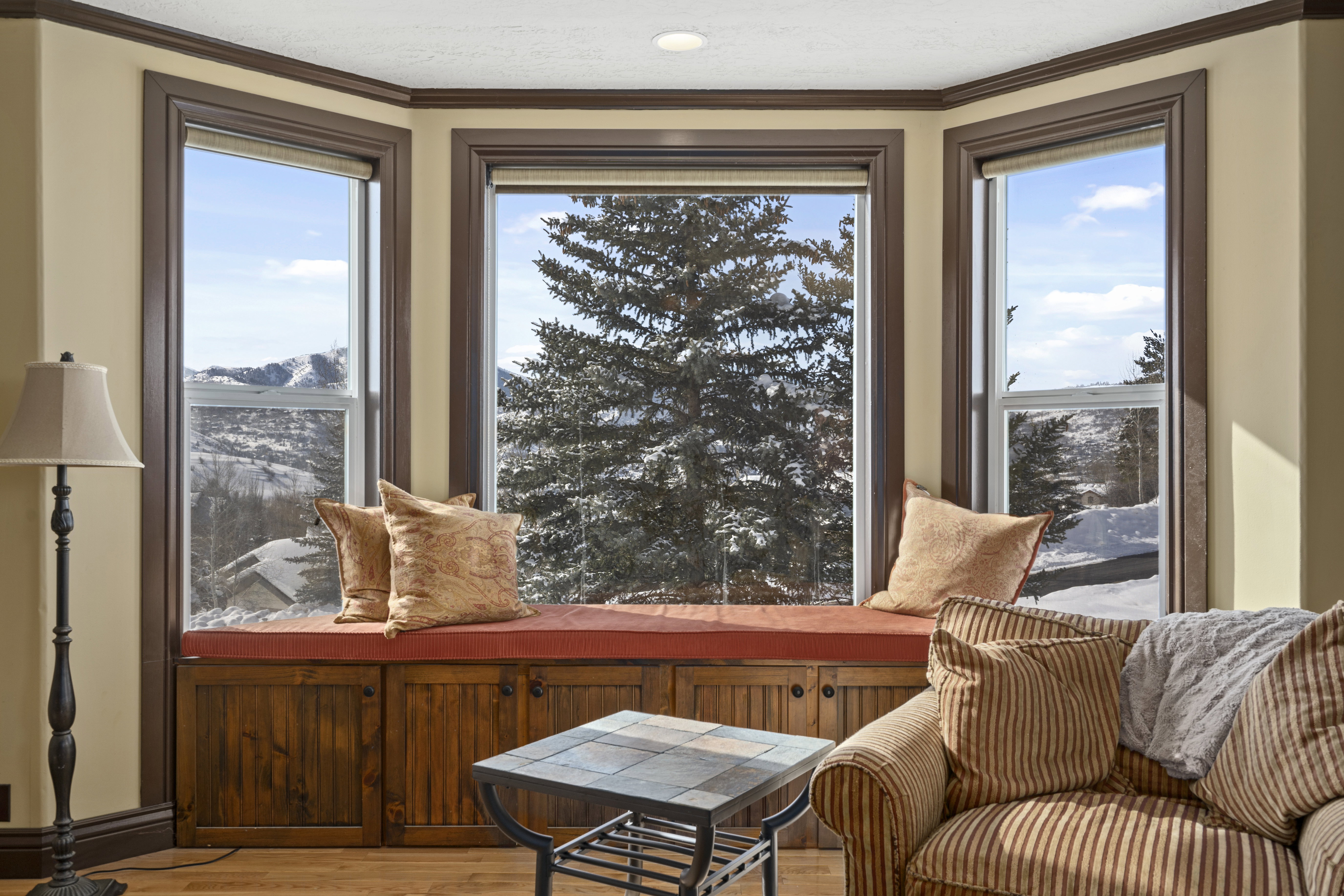 Bay window with a built-in window seat and integrated storage cabinetry