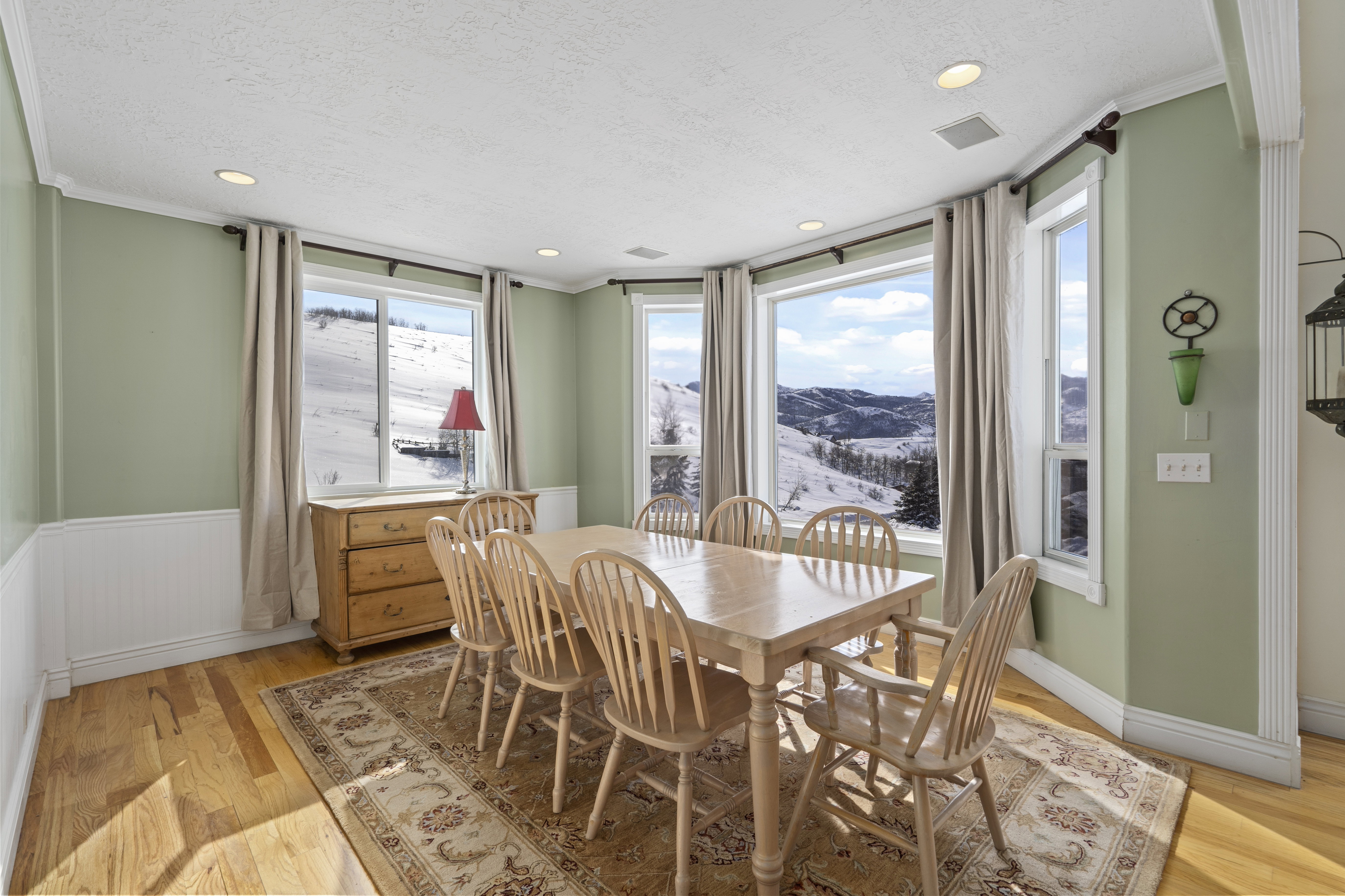 Dining area featuring a bay window with expansive mountain scenery