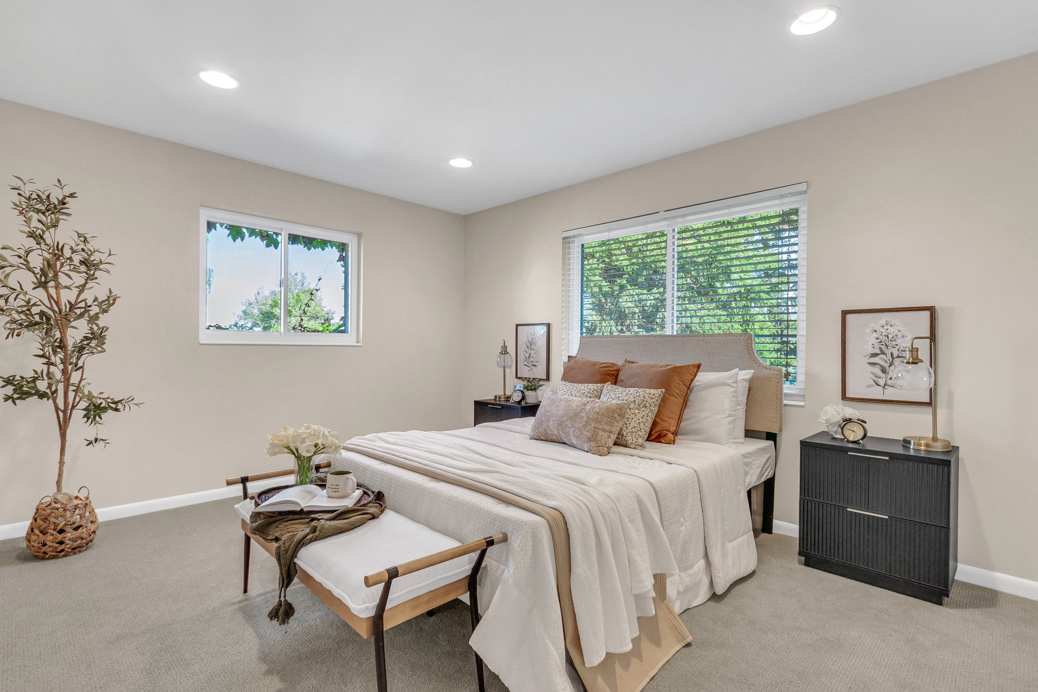 Bedroom featuring two large windows with blinds, recessed lighting, and neutral-toned carpeting