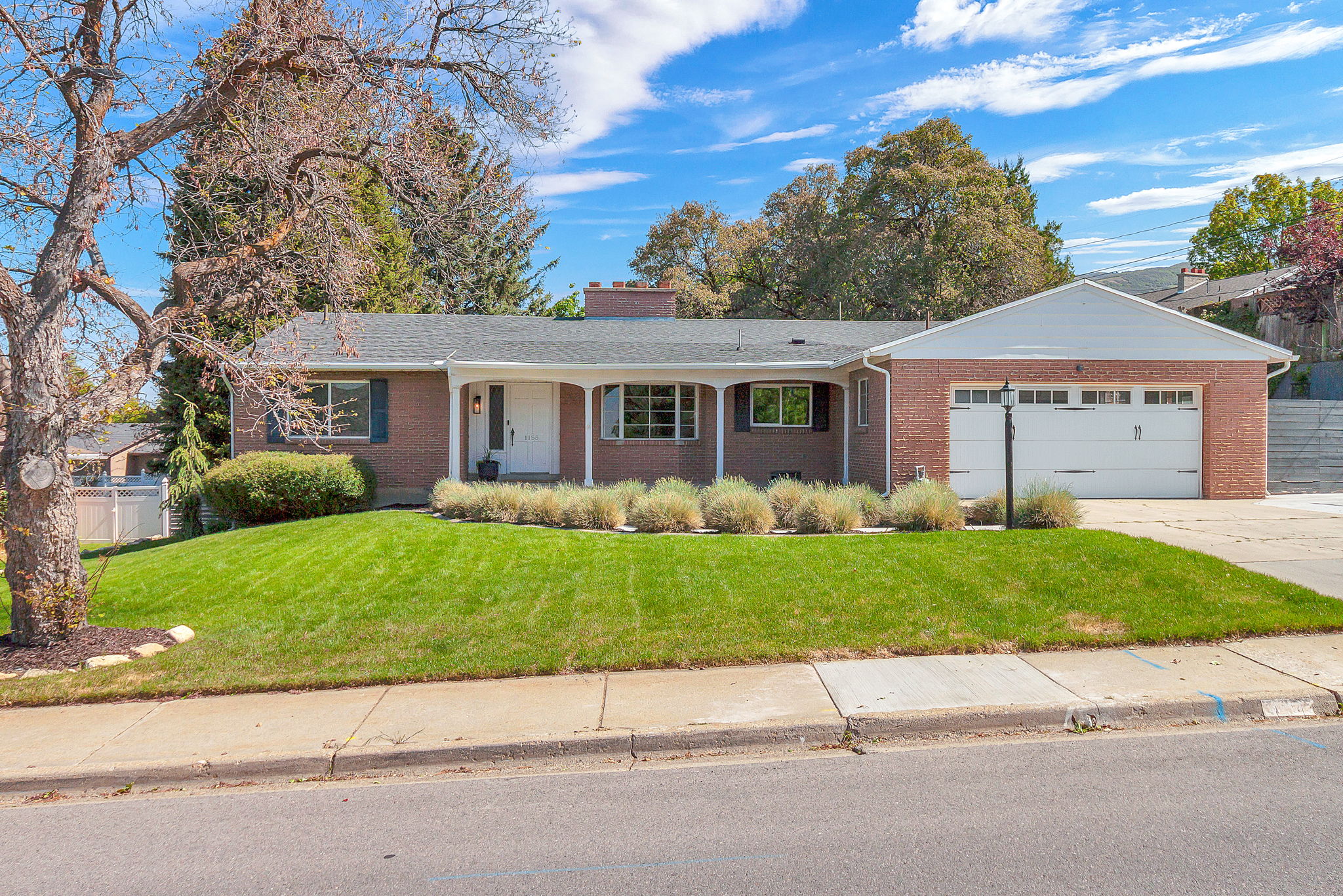 Brick exterior with a covered front porch featuring white columns