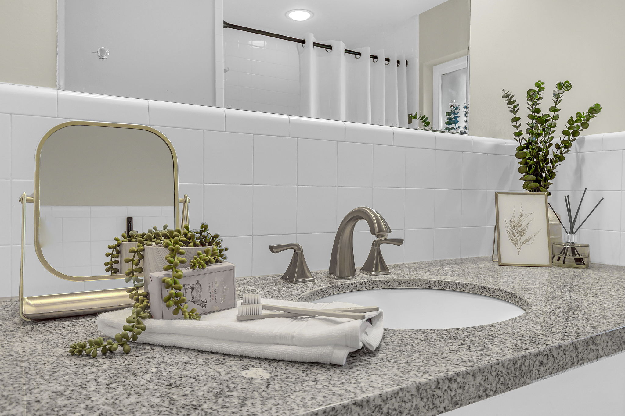 Granite-finish countertop featuring an undermount sink and brushed nickel faucet