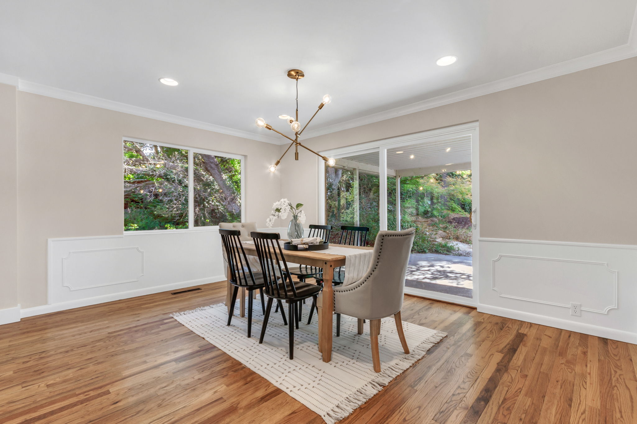Dining area featuring wood-finish flooring and crown molding