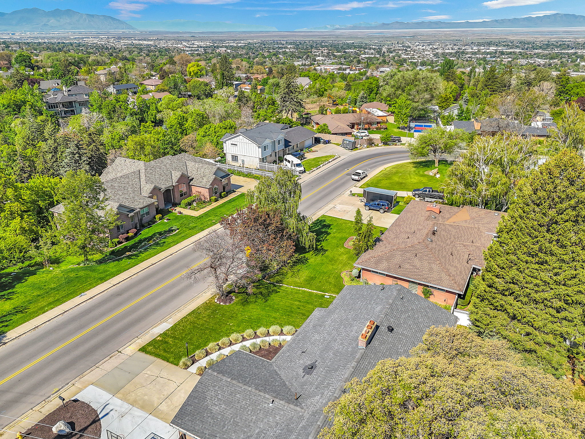 Aerial perspective of a neighborhood with diverse residential architecture and mature trees