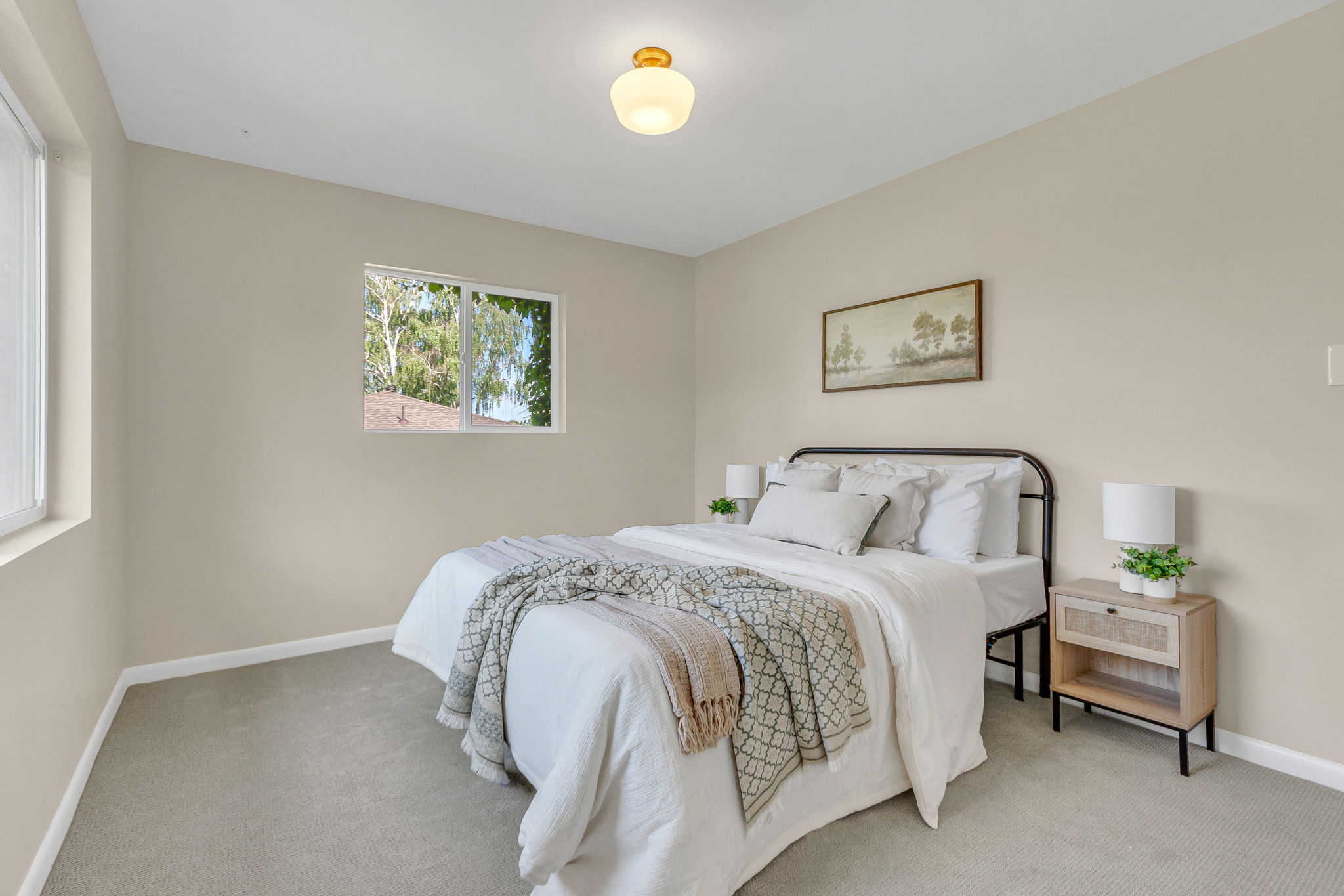 Neutral-toned walls complement light gray carpeting