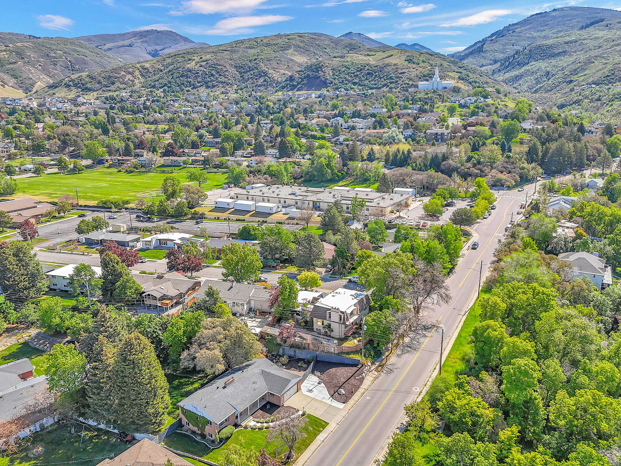 Aerial overview showcasing the property within a verdant, mountainous landscape