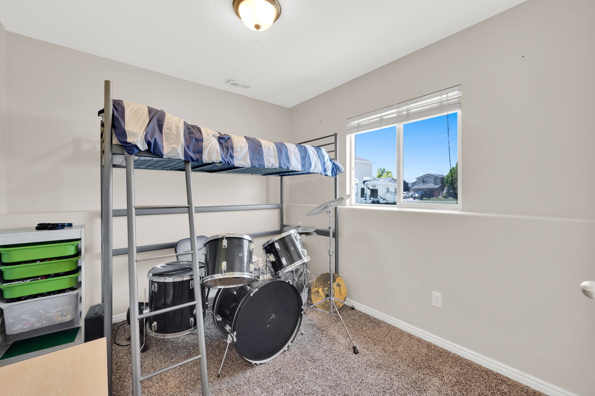 Carpeted room with a double-pane window and neutral wall paint