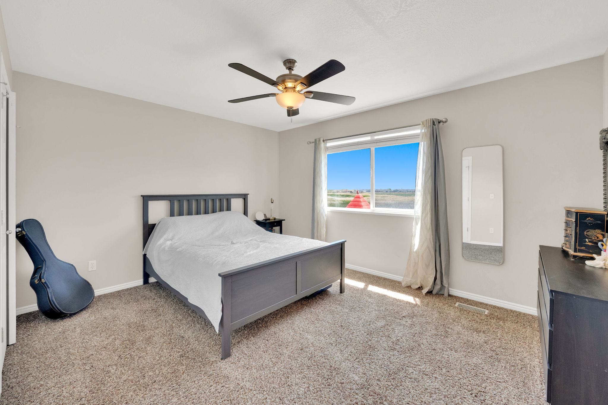 Bedroom featuring neutral-toned carpet flooring and light-colored walls