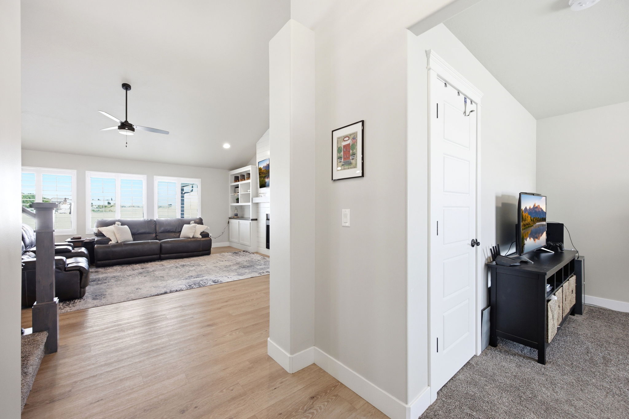 Open-concept living space with wood-finish flooring extending into the main area