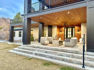 Expansive covered patio featuring a wood-finish ceiling with recessed lighting and a ceiling fan