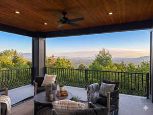 Covered outdoor patio featuring a wood-finish ceiling, recessed lighting, and a ceiling fan