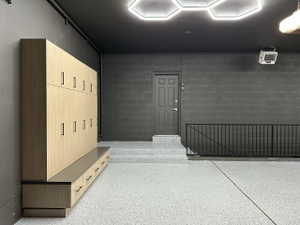 Epoxy flooring with flake finish and a perimeter of dark gray cinder block walls