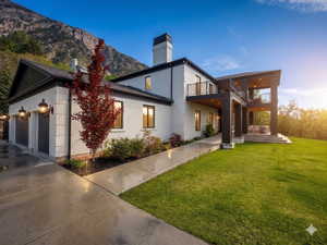White brick exterior with black trim, concrete driveway, and a manicured lawn
