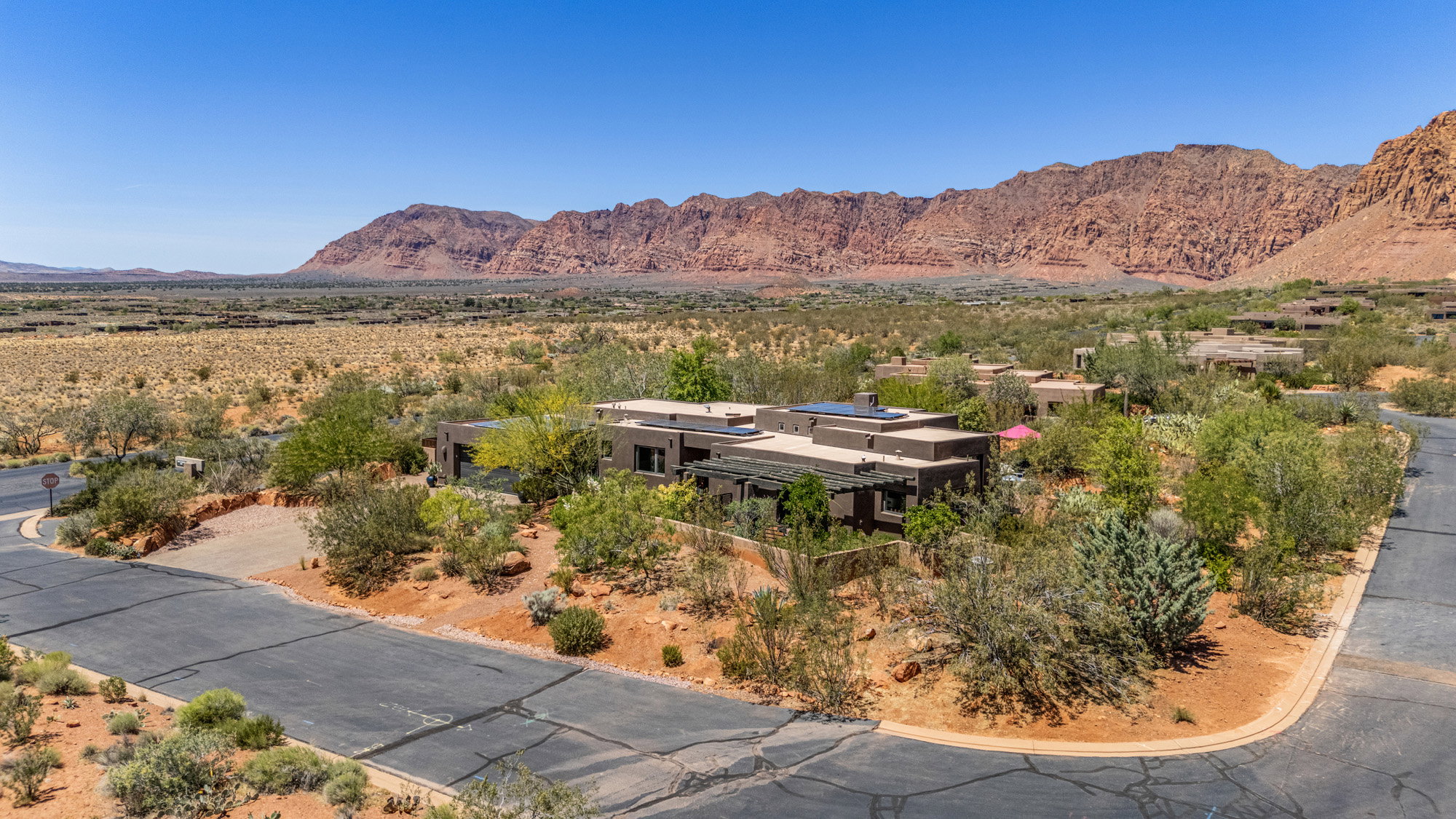 Single-story desert contemporary residence with a flat roofline and integrated solar panels