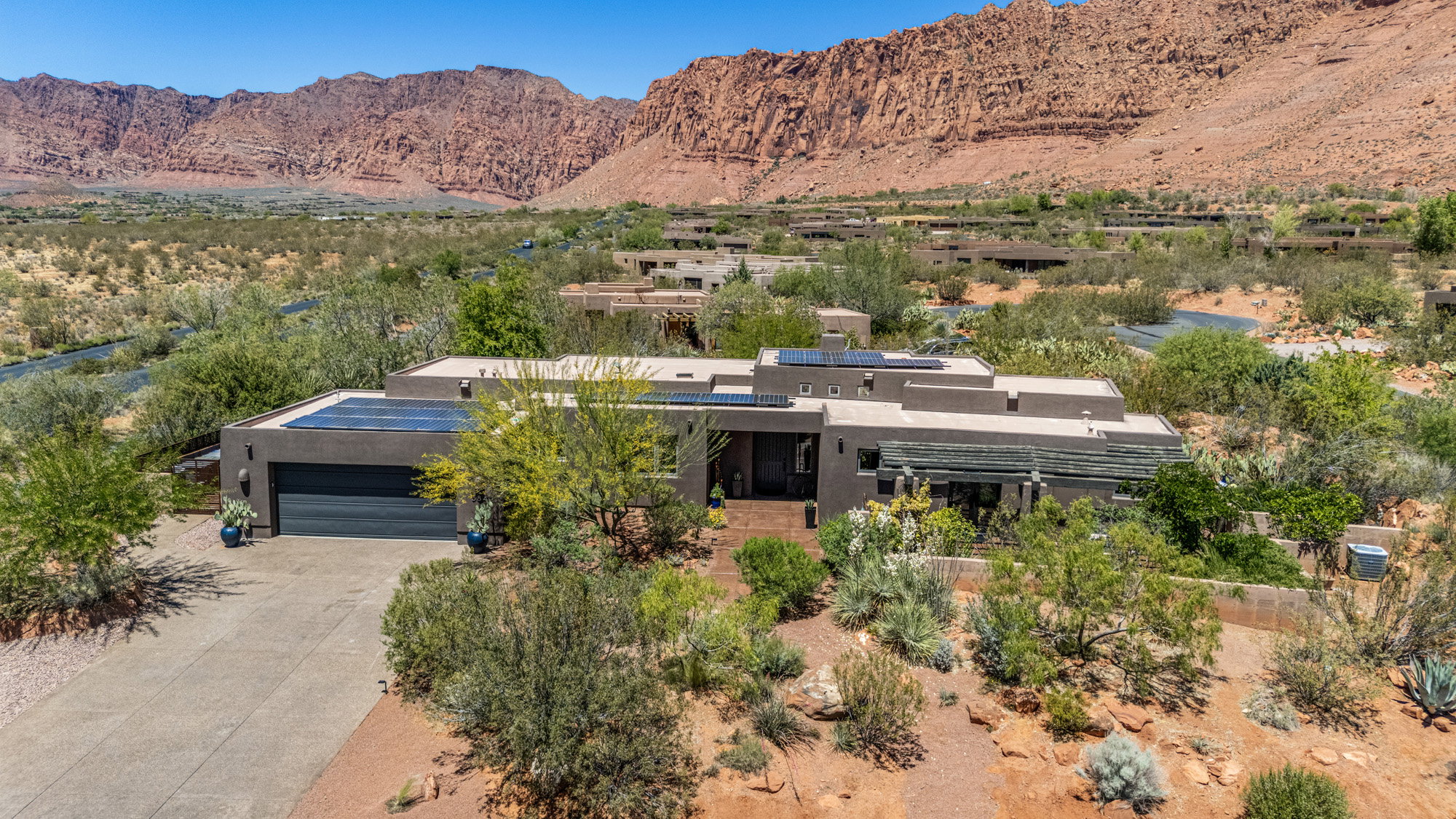 Modern desert architecture featuring a flat roofline and integrated solar panels