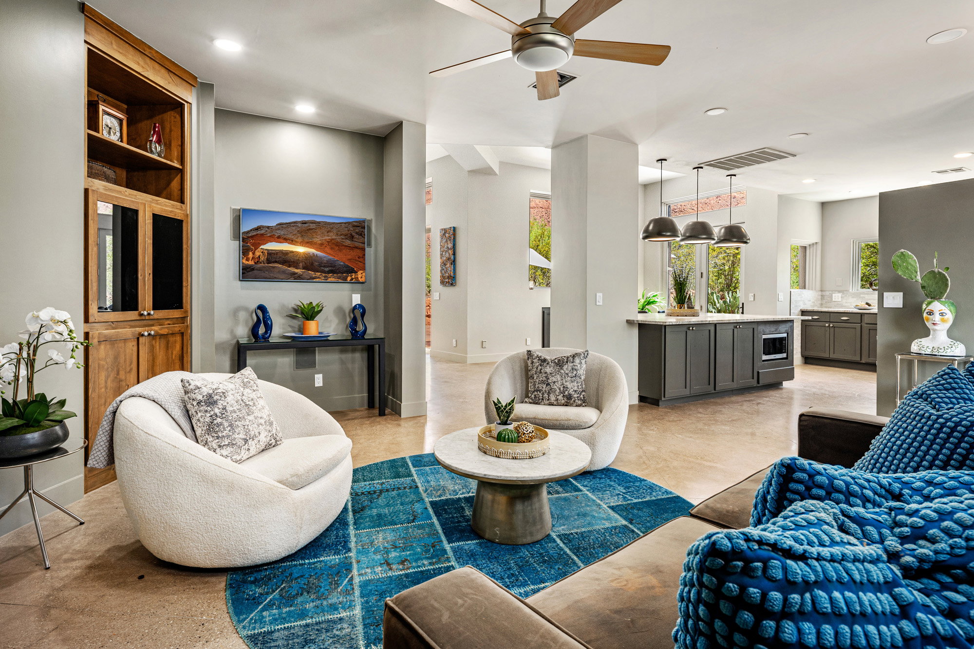 Open-concept living area with concrete flooring, a ceiling fan, and recessed lighting