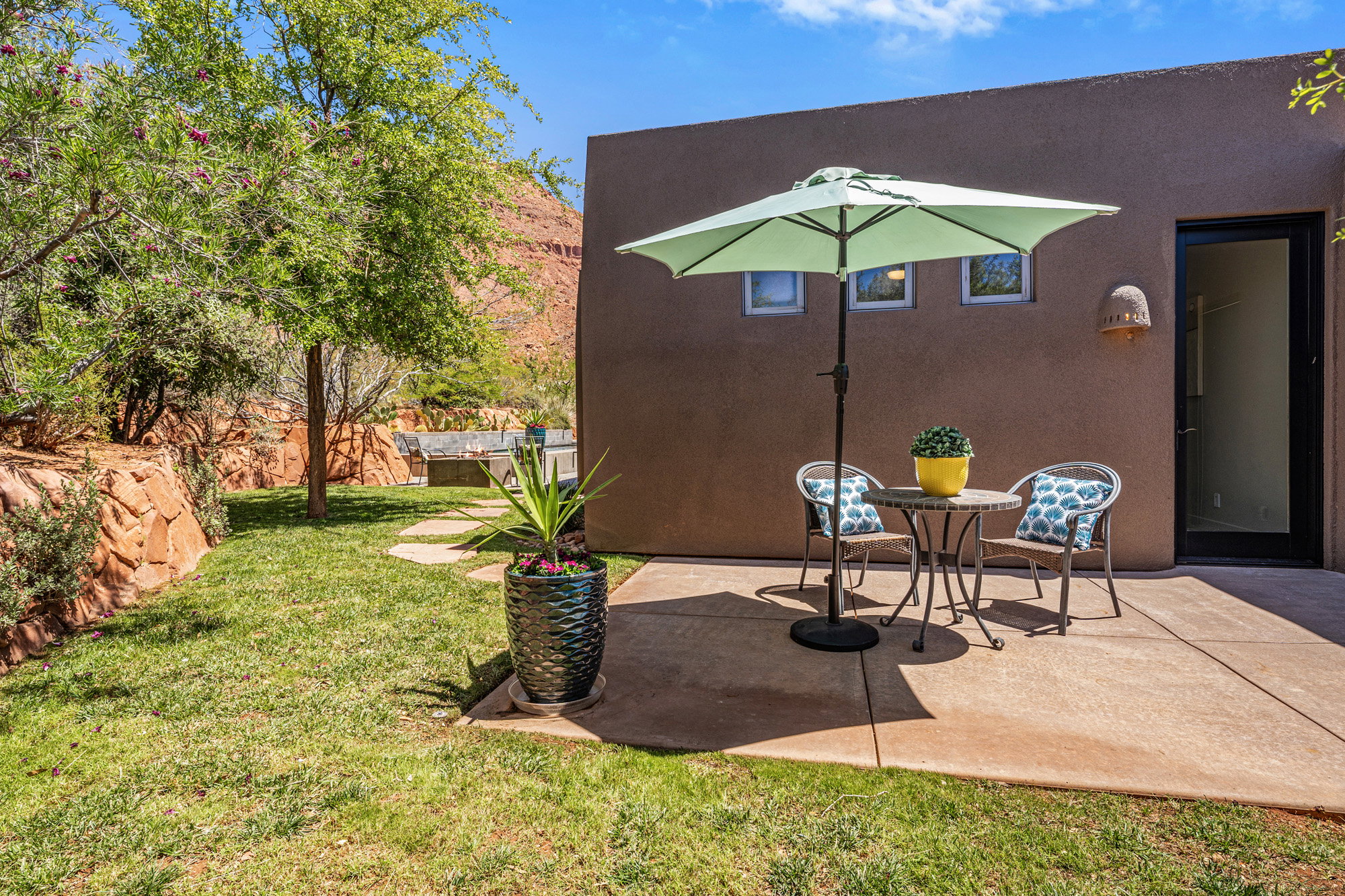 Private patio space featuring a concrete slab, direct exterior access, and three high-set windows